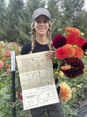 Tracy Hatcher, owner of Brush Prairie Flower Farm, displays the Hockinson Homegrown Highway map. Photo courtesy Hockinson Main Street Team