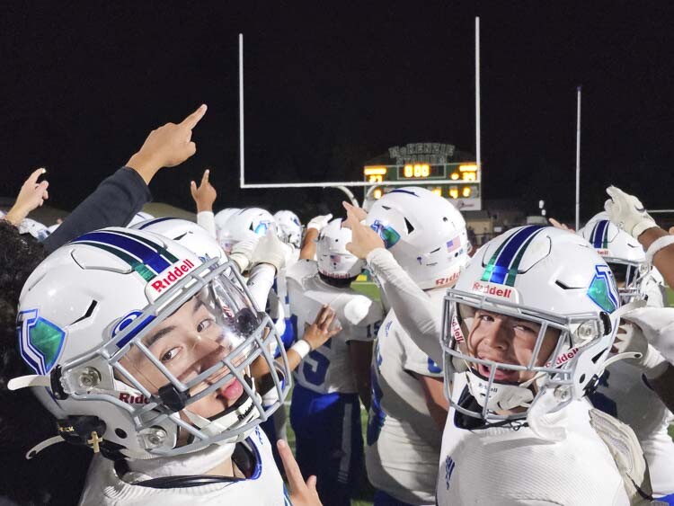 Mountain View football players are all smiles as they point out the scoreboard after Friday’s win over rival Evergreen. The Mountain View defense set the tone early, helping the Thunder to a 39-27 victory. Photo by Paul Valencia