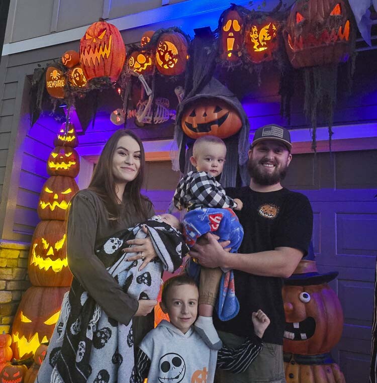 Brittany and James Kugler, along with their children, Noah, 6, Oliver, 2, and Wyatt, 2 months, enjoy their creation, Holiday House at Third, in Ridgefield. Photo by Paul Valencia