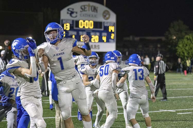Houston Coyle (1) and the La Center Wildcats celebrate their wild comeback victory at Seton Catholic on Friday night. Photo by Mike Schultz