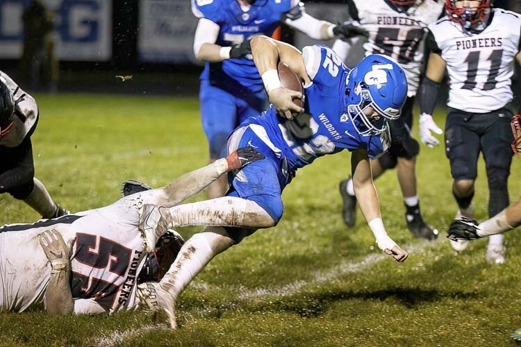 Isaac Chromey fights for extra yards in Friday’s game against Omak. Photo by Mike Schultz