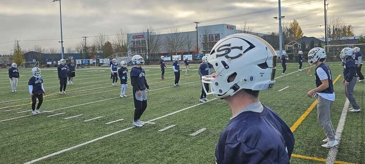 Seton Catholic football players warm up prior to their Thanksgiving Day practice. It is the goal of every high school football player in Washington to practice on the holiday. It means they are in the state semifinals. Photo by Paul Valencia