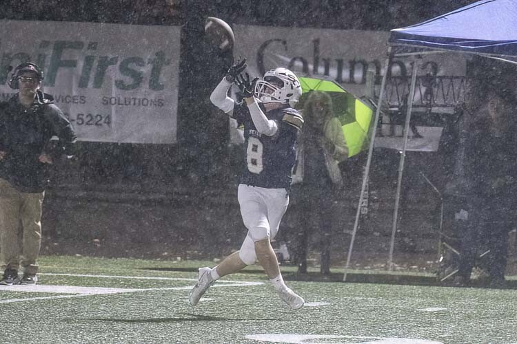 Ryan Stuck maintained his concentration to catch a touchdown pass in a downpour Friday night. Stuck is the only senior on the Seton Catholic roster. Photo by Mike Schultz