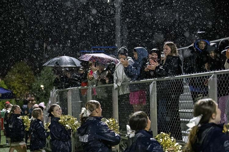 The Seton Catholic cheer squad and students braved the heavy rain during Friday’s victory over Tenino. Photo by Mike Schultz