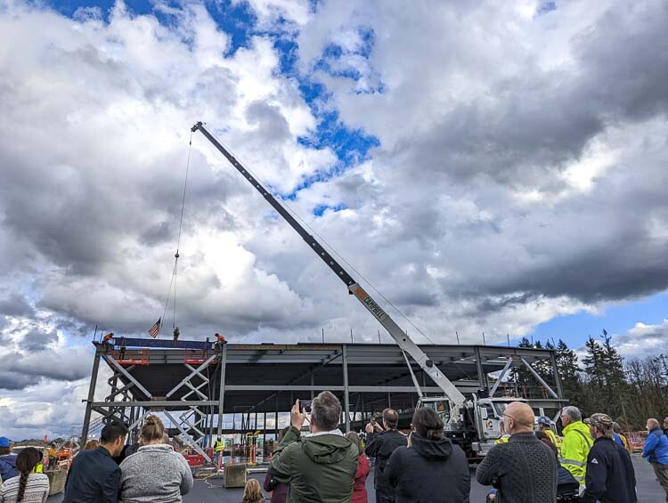 The crowd watches as the beam is lifted into place. Photo courtesy Clark College Communications