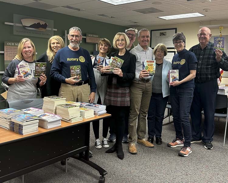 Camas-Washougal Rotarians gather to distribute books to classrooms. Photo courtesy Washougal School District