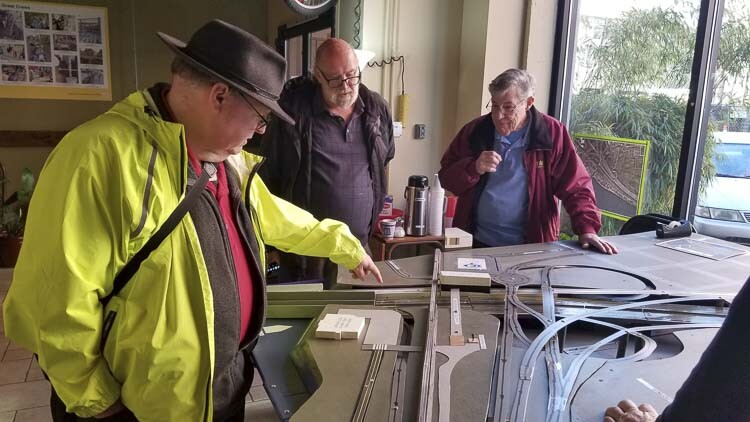 Chris Smith and Hayden Island resident Sam Churchill admire the model as Dave Rowe of Battle Ground looks on. Rowe spent about three months creating the model, using calculations provided by retired engineer Bob Wallis. Photo courtesy John Ley