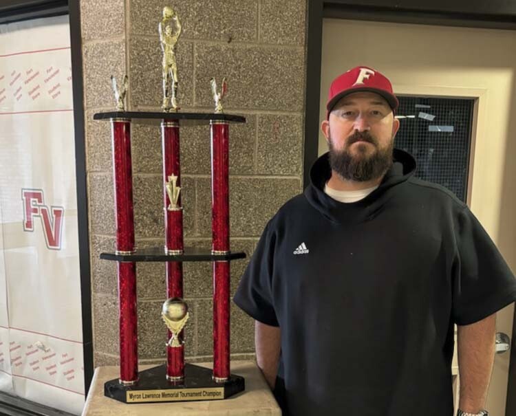 Fort Vancouver boys basketball coach James Ensley stands next to the championship trophy for this year’s Myron Lawrence Memorial Tournament. Previously known as the Fort Vancouver Holiday Invitational, the Clark County-based high school basketball tournament has been renamed in honor of a former Fort Vancouver student and athlete. Photo courtesy Ben Jatos