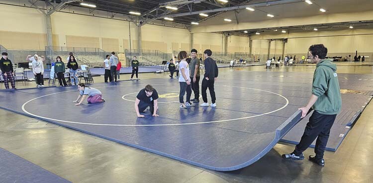 Wrestlers set up one of 12 mats that will be used at this week’s Pac Coast Wrestling Championships at the Clark County Event Center at the Fairgrounds. Photo by Paul Valencia