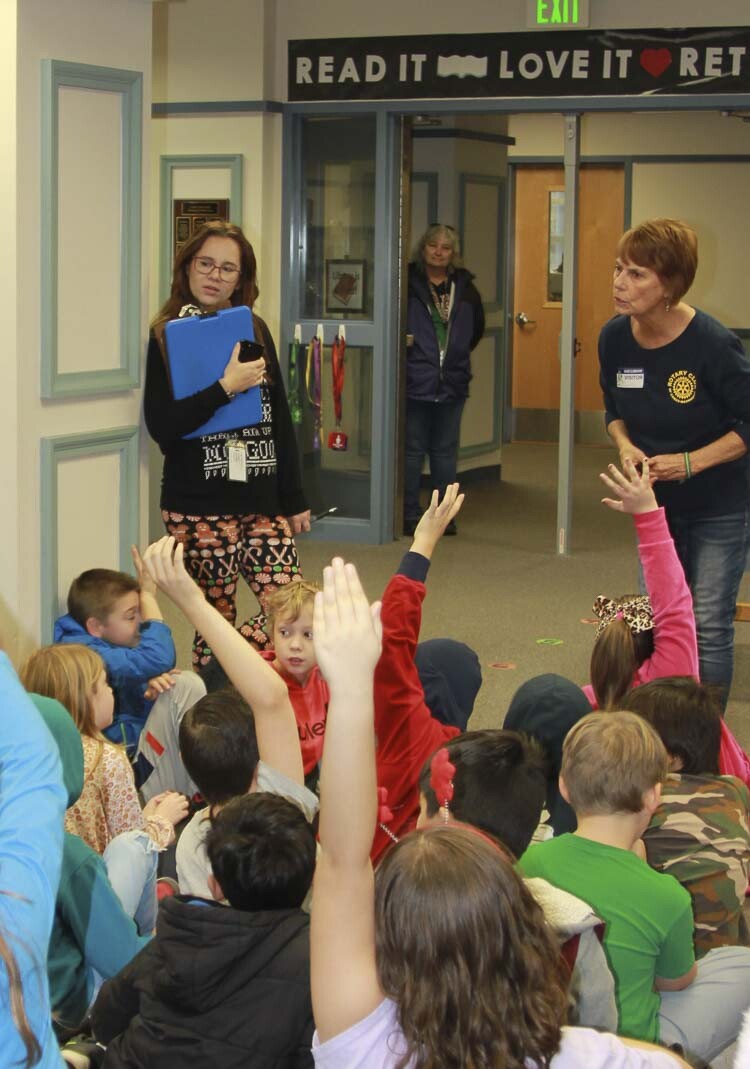 Rotarians answer student questions while donating books. Photo courtesy Washougal School District