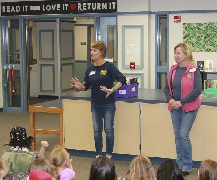 Rotarians talk about the Rotary Club to Gause students while presenting new classroom reading materials. Photo courtesy Washougal School District