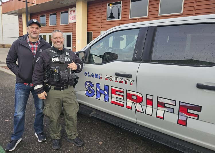 John Horch, the Clark County Sheriff, and DuWayne Layton, deputy sheriff, appreciate the partnership between law enforcement and the community, rallying behind the cause for Santa’s Posse. Photo by Paul Valencia