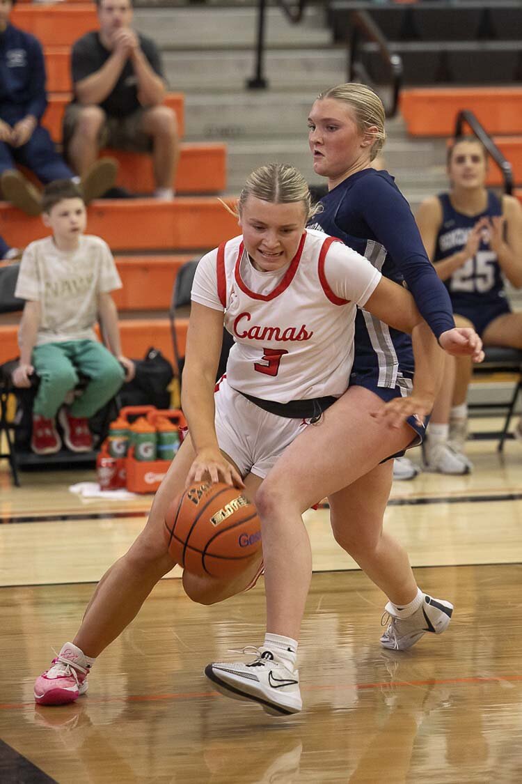 Riley Sanz drives around her opponent on the way for a reverse layup. Sanz scored 15 points to lead Camas to a win over Gonzaga Prep on Saturday in the Class 4A girls basketball state tournament. Photo by Mike Schultz