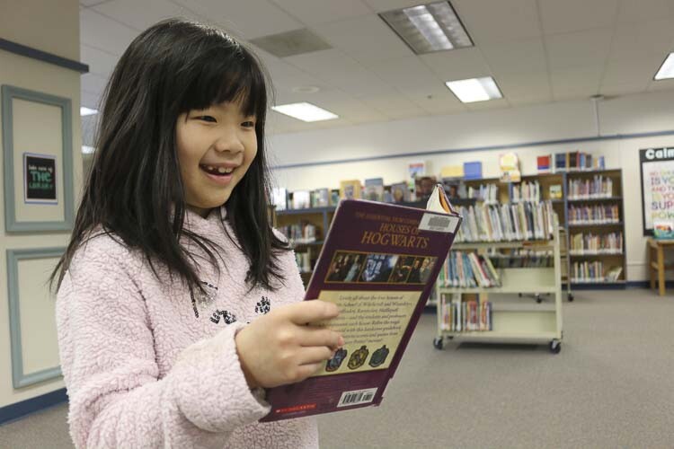 Ema Sunada, 2nd grade, reading a book in the Gause Library. Photo courtesy Washougal School District