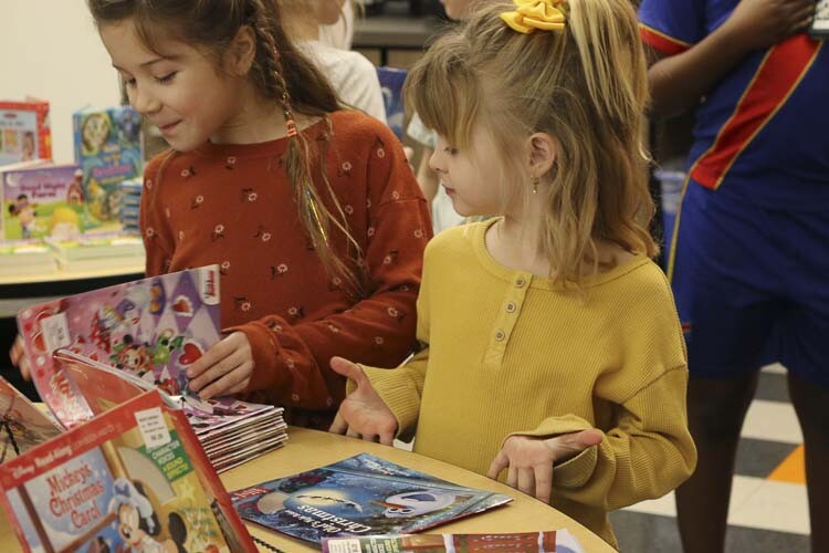 Henley Johnson and Emily Gentry each pick out one free book from the Read Northwest book giveaway at Columbia River Gorge Elementary School. Photo courtesy Washougal School District