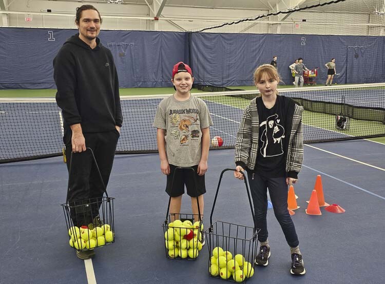 The Vancouver Tennis Center is offering Just Serve Autism classes, featuring professional instruction for children with special needs. Here Stefan Lagielski, associate head pro, poses with Evan Tooley and Alexandria Bauer during a session last week. Photo by Paul Valencia