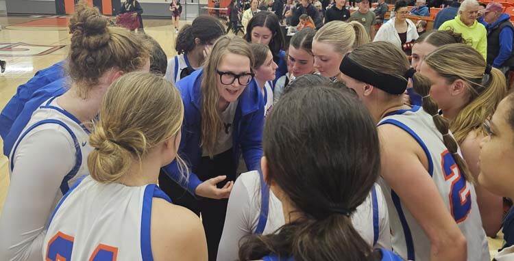 Ridgefield coach Lauren Hefflin shares a moment with her team just after the Spudders beat Kingston in a Class 2A girls basketball state tournament game Friday in Battle Ground. Photo by Paul Valencia