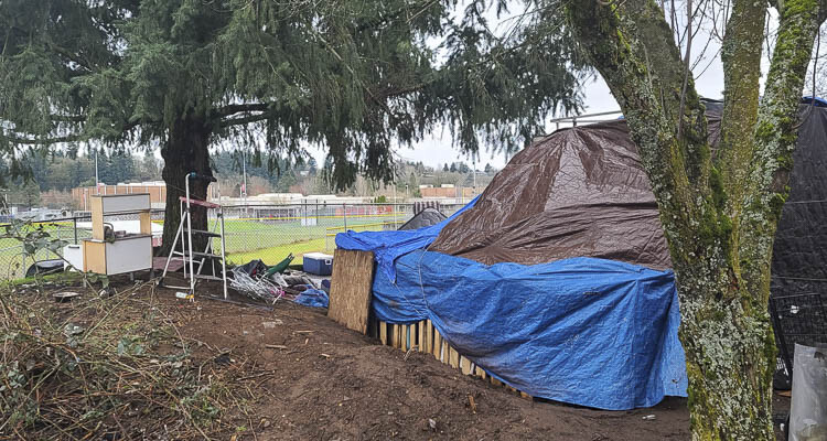 This photo taken in March 2023 shows a homeless camp just on the city side of a fence around the campus of Fort Vancouver High School. The site was later cleaned up by the city. Photo by Paul Valencia
