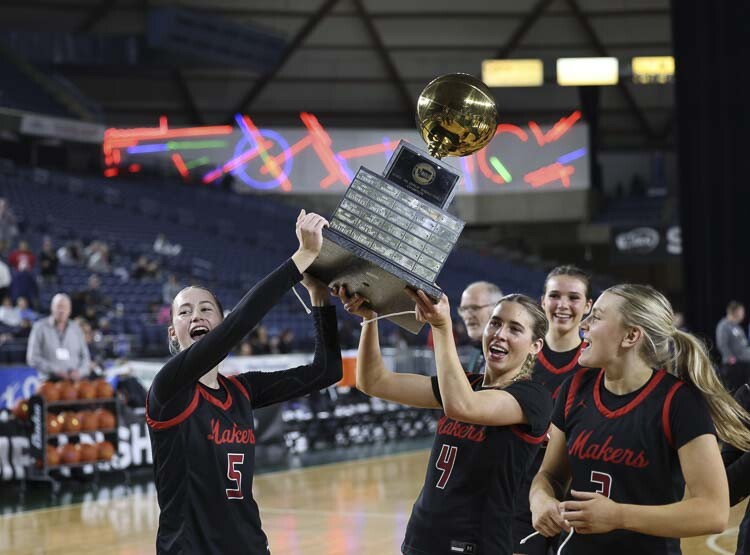 Camas players Parker Mairs (5), Sophie Buzzard (4) and Riley Sanz (3) get their turn with the state championship trophy. Photo courtesy Mike Schultz
