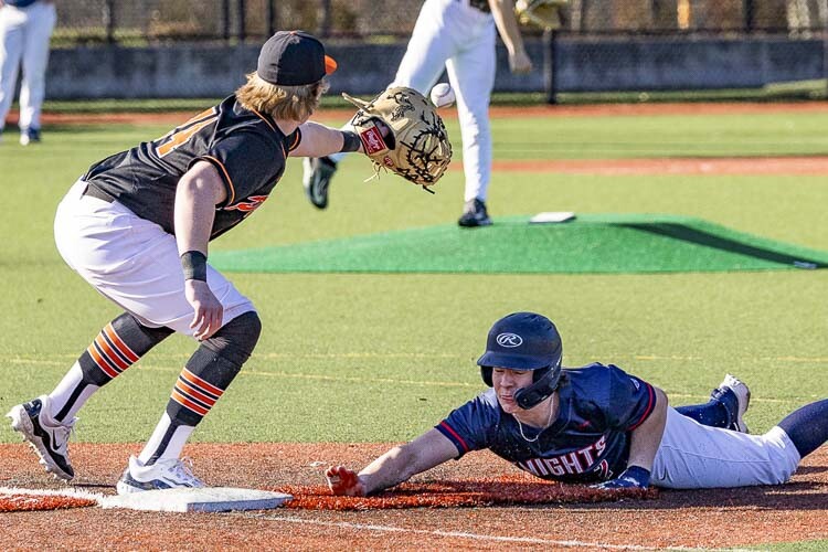 King’s Way Christian’s Jace Barnes slides back safely to first base Thursday during the Knights’ home game against Washougal. Photo by Mike Schultz