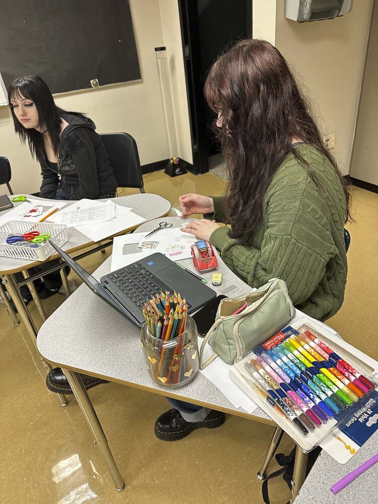 Samantha Zoeller (left) and Riley Williams (right) create custom stickers in WHS craft club. Photo courtesy Washougal School District