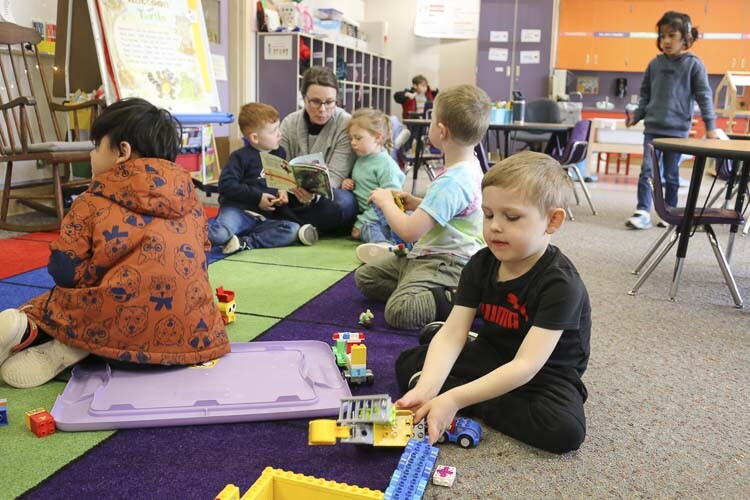 Students in TK engage in purposeful play in foreground while students listen to a book being read aloud in the background. Photo courtesy Washougal School District