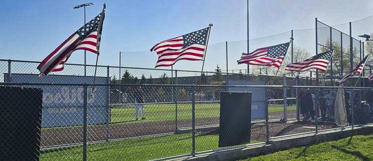 Large American flags were posted on the fence surrounding the dugout at Union High School’s baseball field Tuesday for Honor Game. Photo by Paul Valencia