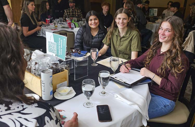 Celia Langarica, Bristol Bunce, and Lyla Hart, some of the top senior students in the Construction Tech program at Cascadia Technology Academy, set up interviews with Pacific Crest Cabinets. Dozens of construction program students from Clark County had a luncheon on Wednesday with two dozen employers looking to hire young, talented, and motivated people. Photo by Paul Valencia