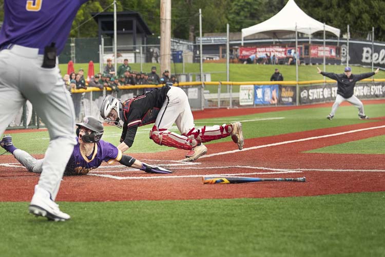 Columbia River senior Charlie Palmersheim slid under the tag at the Class 2A state championship baseball game last weekend. In the background, Columbia River coach Stephen Donohue is making the call for the umpire. The umpire agreed. Palmersheim was safe, giving Columbia River a 3-2 lead, and the Rapids would end up winning the state championship. Photo courtesy Kim Blau