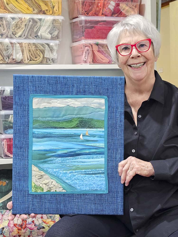 Sandy Moore is shown here with her artwork, “Sail Boats. Photo courtesy Washougal Arts and Culture Alliance