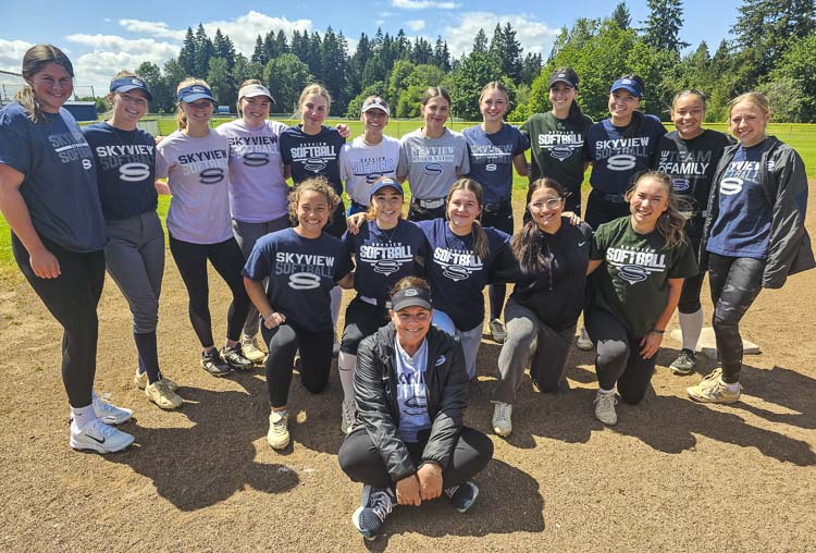 Skyview softball coach Kim Anthony (sitting) and her players are heading to the state tournament this weekend as the No. 1 seed. Anthony was a star at Columbia River in the late 1980s and her college team, UNLV, was just recently honored by the university’s Hall of Fame. Photo by Paul Valencia