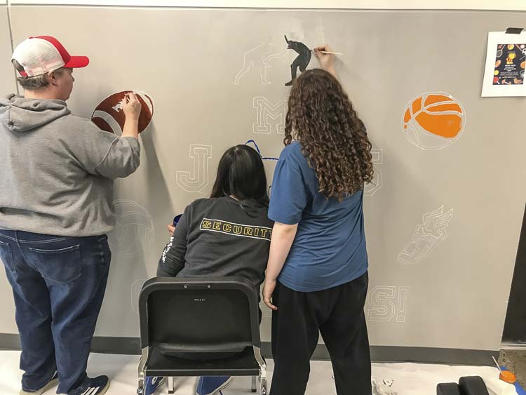 Teacher Dani Allen, students Rylee Drake, and Aubrey Gale paint mural at Jemtegaard Middle School. Photo courtesy Washougal School District