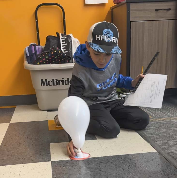 A student prepares to launch a balloon-powered hovercraft. Photo courtesy Washougal School District