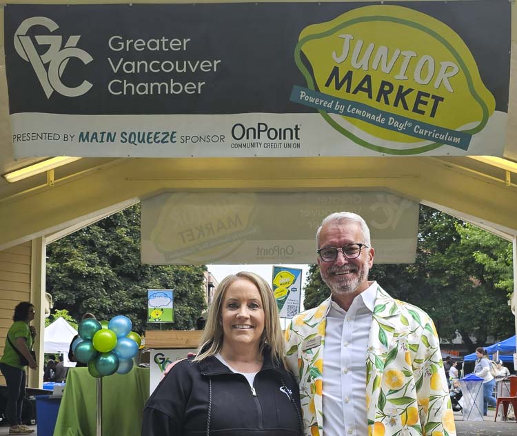 Janet Kenefsky of the Greater Vancouver Chamber and Tim Clevenger of OnPoint Community Credit Union celebrated the opening of the Junior Market on Saturday morning, the third year in a row for the event featuring youth entrepreneurs. Photo by Paul Valencia
