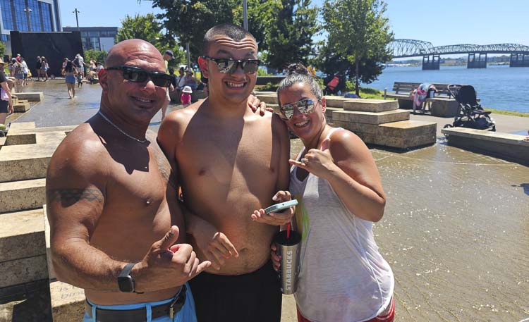 Aloha from Vancouver! The Wilcox family, from Hawaii, is now living in Vancouver and enjoying the water feature at the Vancouver Waterfront Park. Left to right is Kalae Wilcox, 14-year-old Kanoa, and Corinna Wilcox. Photo by Paul Valencia