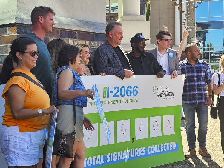 Brian Heywood and Vancouver’s Cemal Richards pose with a group of I-2066 supporters at the Sec. of State office. The sign reveals the 546,002 signatures gathered. Photo by John Ley