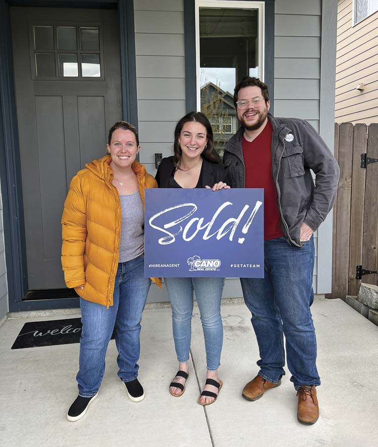 Clients Samantha and Lucas Wiseman are shown here with Cano Real Estate Broker Megan Storie (center). The Wisemans purchased a home in Ridgefield in 2022 with the help of Storie. Photo courtesy Cano Real Estate