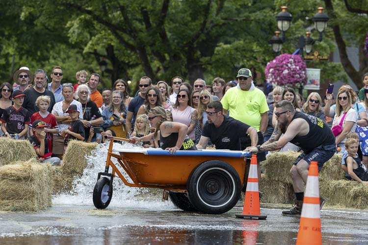 Chuck’s Towing Team loses a bit of its water while making a turn at the bathtub races and spectators look on in amazement during the annual spectacle at Camas Days. Photo by Mike Schultz