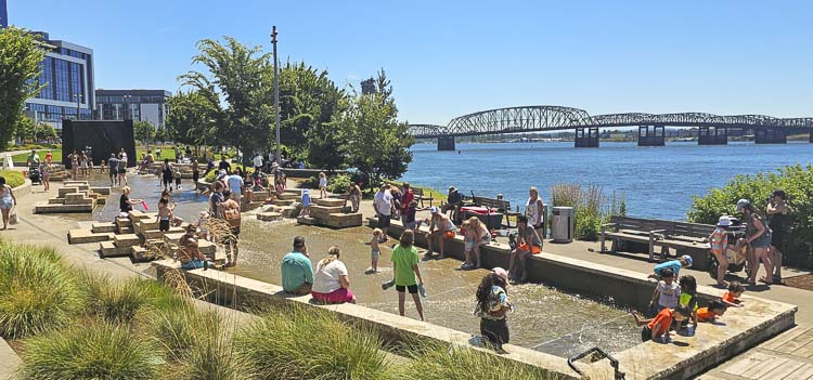 Saturday’s high temperature was 99 degrees in Vancouver, and residents showed up at the Columbia River Water Feature at Vancouver Waterfront Park to find some relief. Photo by Paul Valencia