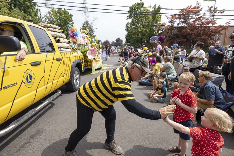 Lions and bees, working together at Camas Days. It’s Brian Scott, the president of the Lions Club, dressed up as a bee, talking to parade watchers at Camas Days. Photo by Mike Schultz