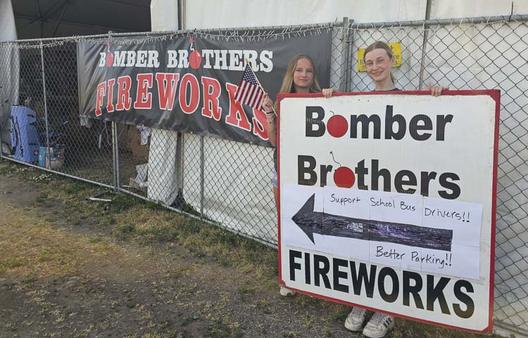 Sisters Kaydence Karren and Tacy Karren promote the Bombers Brothers fireworks store on NE 117th Avenue, just outside the Vancouver city limits. Fireworks are illegal in Vancouver but not in unincorporated Clark County. Photo by Paul Valencia