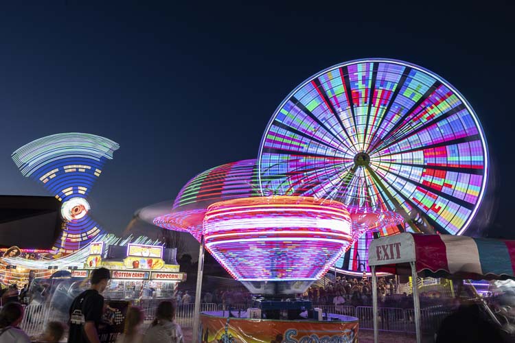 The lights come on after dark at the Clark County Fair, bringing a new vibe to the fairgrounds. Photo by Mike Schultz