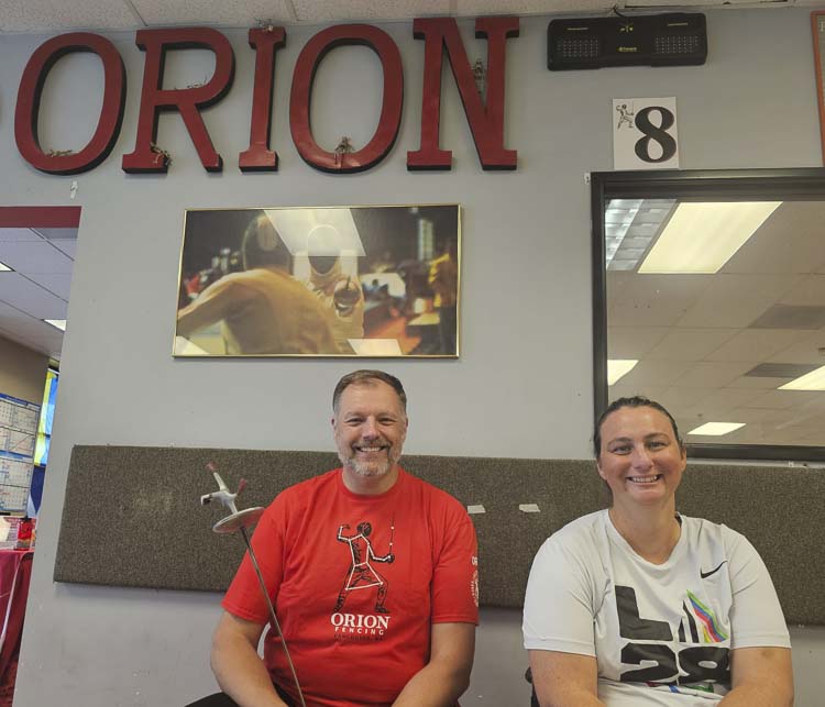 Justin Meehand, left, is the owner of Orion Fencing in Vancouver. He also is Ellen Geddes’ coach. Geddes will be competing in Paris in September, representing the United States at the Paralympic Games. Photo by Paul Valencia