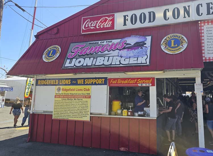 A Lion Burger sounds really good right now, doesn’t it? Don Lasher started volunteering at the Ridgefield Lions Club food booth at the Clark County Fair in 1975 and now his whole family helps him run the booth. Photo by Paul Valencia