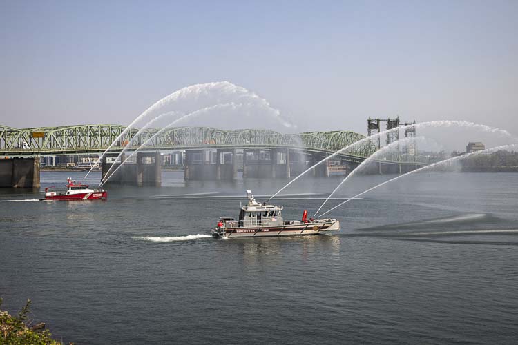 A pair of fire boats, including one from the Vancouver Fire Department, helped provide the visuals for Thursday’s event on the Columbia River near the I-5 Bridge. Photo by Mike Schultz