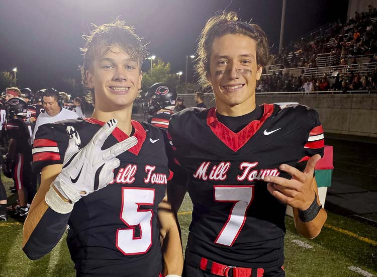 Camas football players Chase McGee (5) and Jake Davidson are all smiles, sporting their new uniforms that showcase Camas as Mill Town. Photo by Paul Valencia