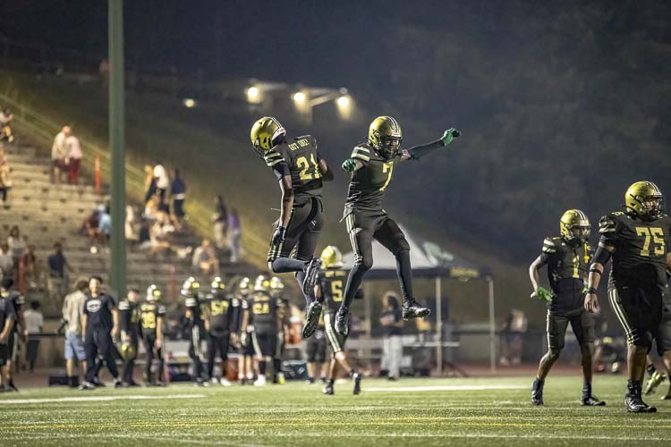 Evergreen’s Elijah English (21) and Thaddeus Pruitt (7) celebrate their team’s win over Union to open the 2024 high school football season Friday night at McKenzie Stadium. Photo courtesy Heather Tianane