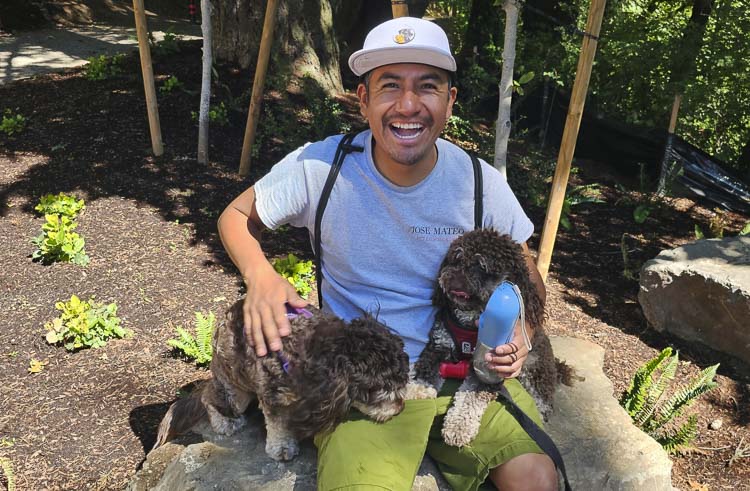 Jose Mateo is all smiles at his job, as the owner of He Walks Dogs. Photo by Paul Valencia