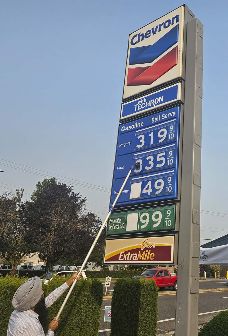 Gary Bains, owner of the Chevron on the corner of NE Andresen Road and NE 25th Street in Vancouver, changes the prices of gas on the sign. Let’s Go Washington lowered the price to the national average, going from close to $4.20 a gallon to $3.20 a gallon for two hours Friday morning. Photo by Paul Valencia