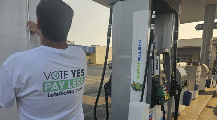 A volunteer for Let’s Go Washington as he was getting ready for the two-hour Gas Rollback event at a Vancouver gas station. Photo by Paul Valencia